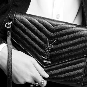 Real YSL clutch in black with silver hardware.